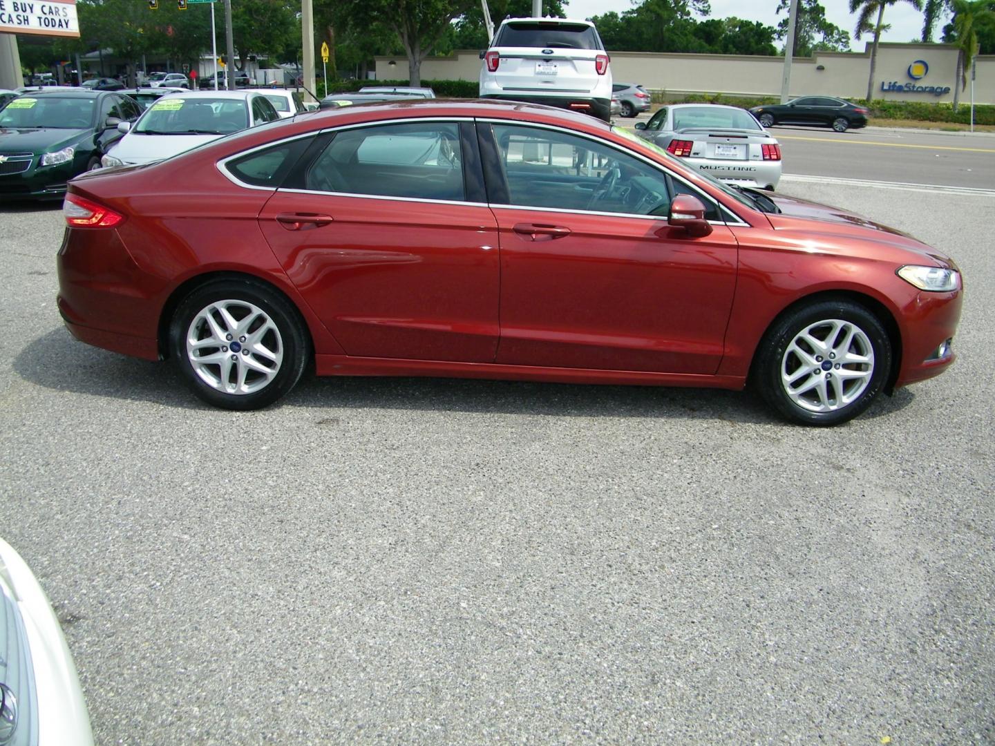 2014 Orange /Black Ford Fusion SE (3FA6P0HD7ER) with an 1.5L L4 DOHC 16V engine, Automatic transmission, located at 4000 Bee Ridge Road, Sarasota, FL, 34233, (941) 926-0300, 27.298664, -82.489151 - Photo#6